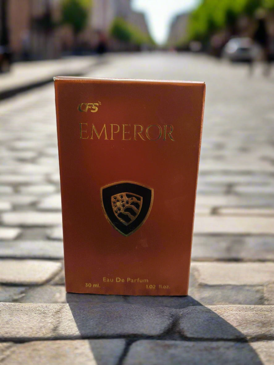 Red perfume bottle labeled 'Emperor' with a logo on a marble countertop.